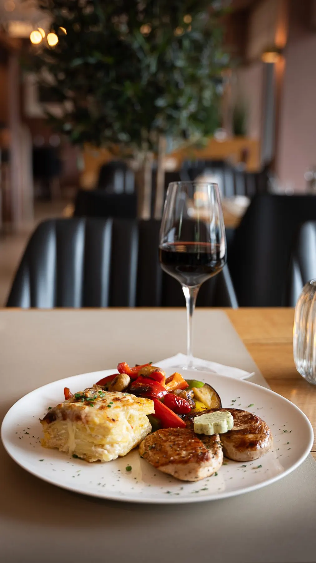 Schweinefilet mit Gratin und einem Glas Rotwein